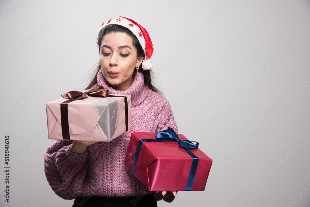 Yung santa girl cleaning dust from the gfits Yung santa girl cleaning dust from the gfits