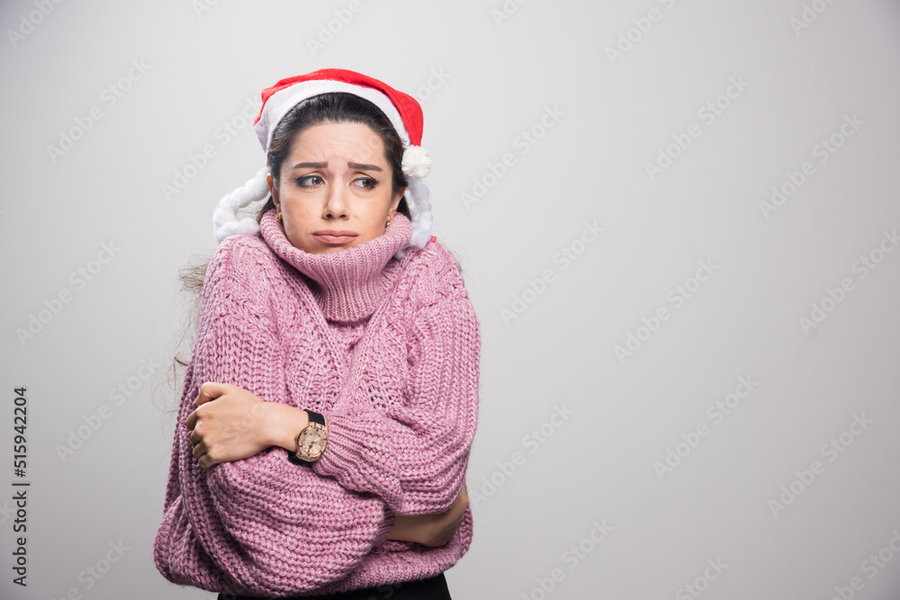 Freezing girl with santa hat and sweater