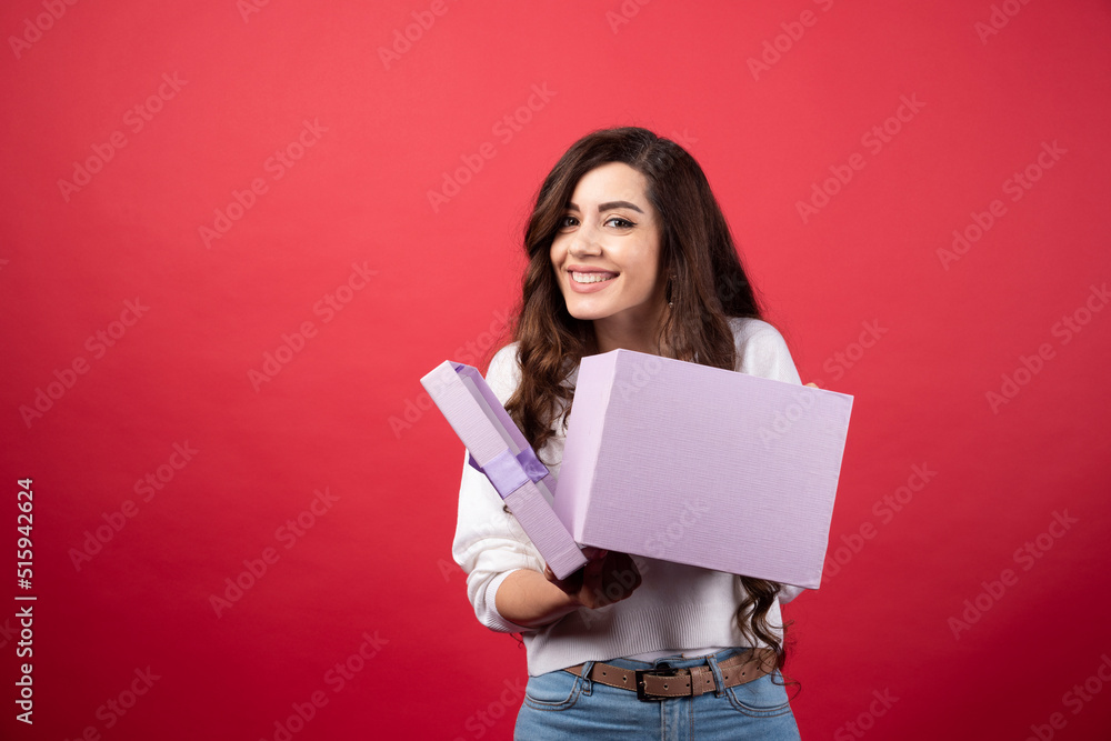 Beautiful woman posing with purple present box Beautiful woman posing with purple present box