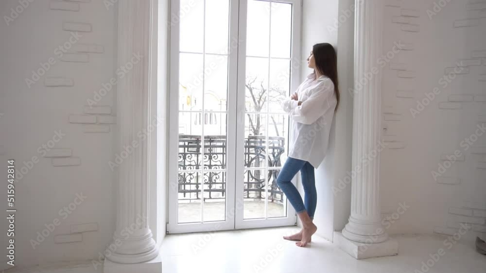 Slow Motion Young beautiful woman looking out window Slow Motion Young beautiful woman looking out window