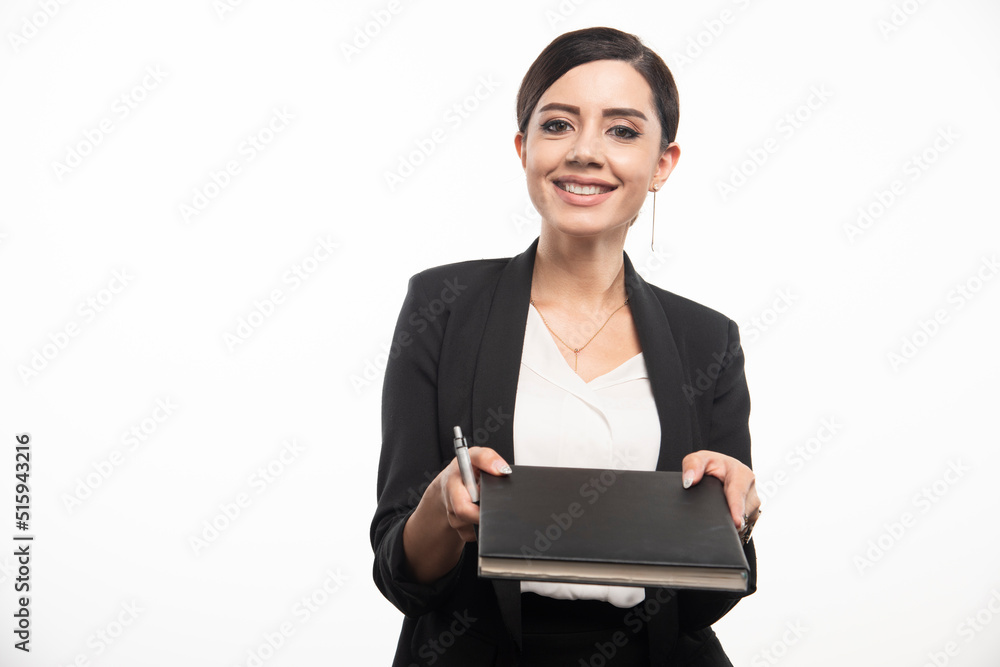 Young employee giving notebook on white background Young employee giving notebook on white background