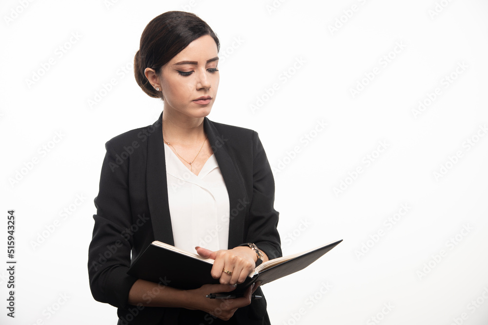 Young woman reading notebook on white background Young woman reading notebook on white background