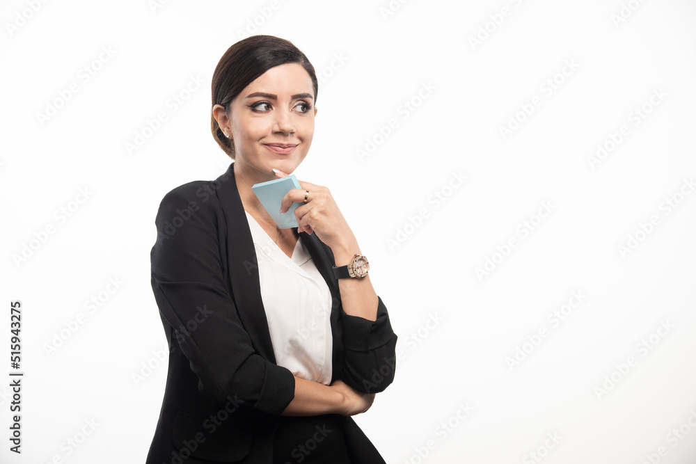 Female employee holding memo pad on white background Female employee holding memo pad on white background