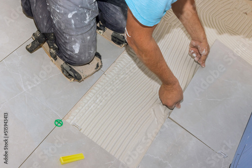 Tile adhesive is applied to glue-smeared floors when laying ceramic tiles in renovation home works