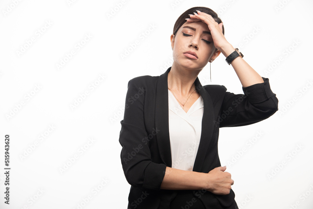 Business woman posing in suit on a white background Business woman posing in suit on a white background