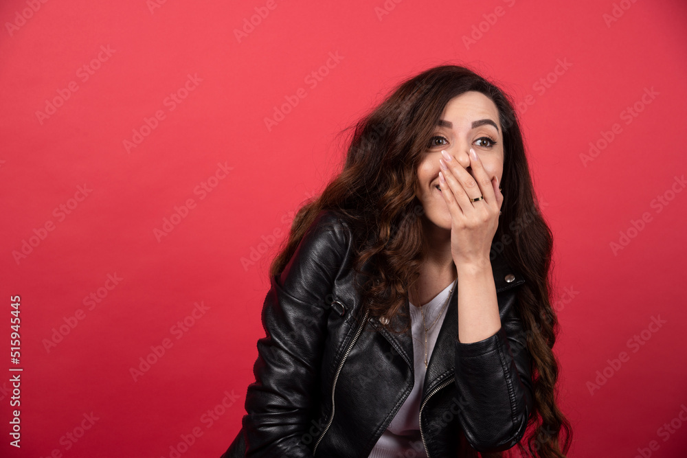 Young woman posing on a red background Young woman posing on a red background