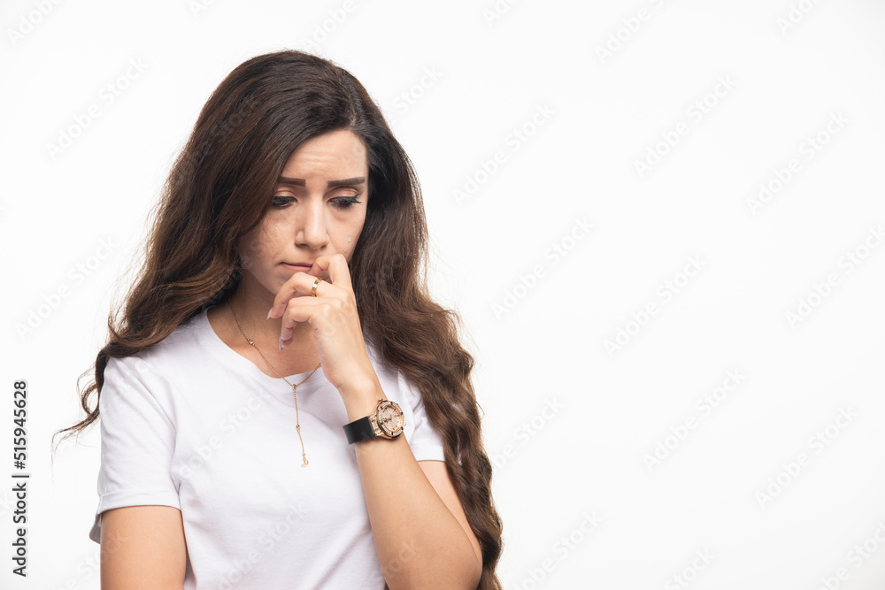 Long haired woman in white shirt feeling depressed Long haired woman in white shirt feeling depressed