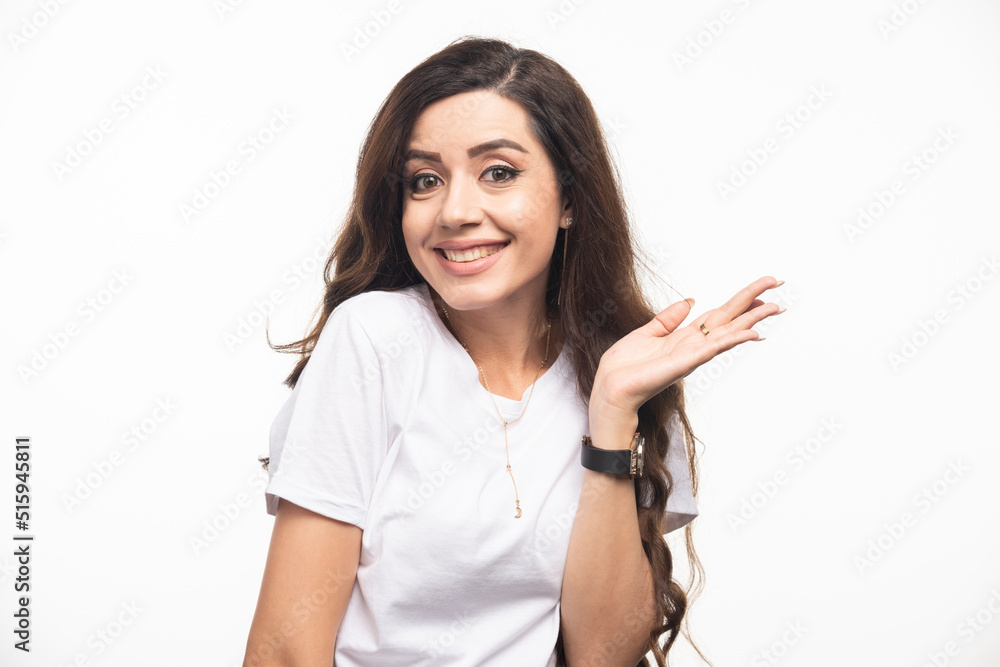 Young pretty woman in white shirt posing on white background Young pretty woman in white shirt posing on white background