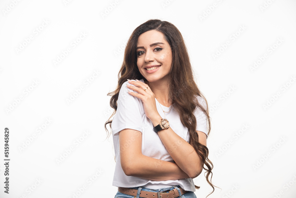 Wavy haired woman in white shirt posing on white background Wavy haired woman in white shirt posing on white background