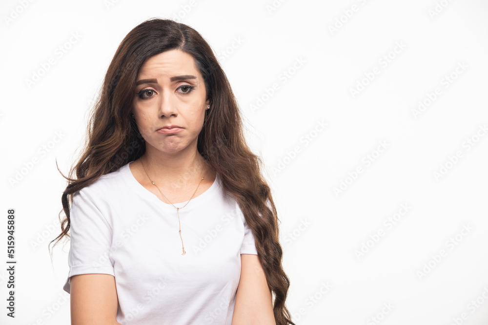 Long haired woman in white shirt feeling depressed Long haired woman in white shirt feeling depressed