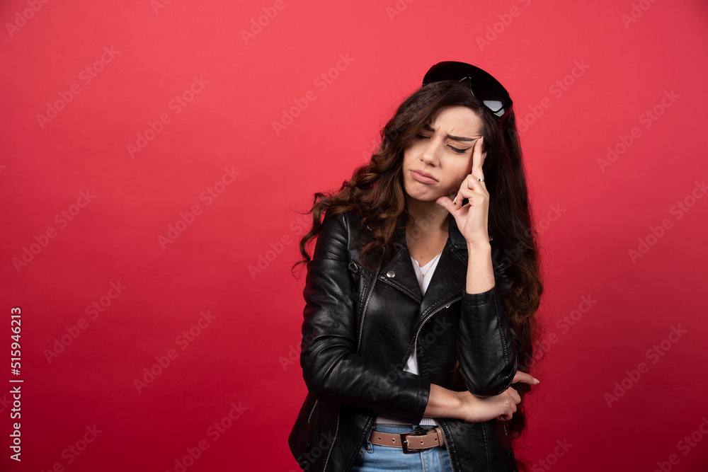 Young woman posing with black glasses on a red background Young woman posing with black glasses on a red background