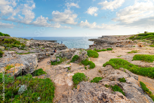 A rocky coastline on the Mediterranean Sea at the village of Binibeca Vell on the island of Menorca, Spain.