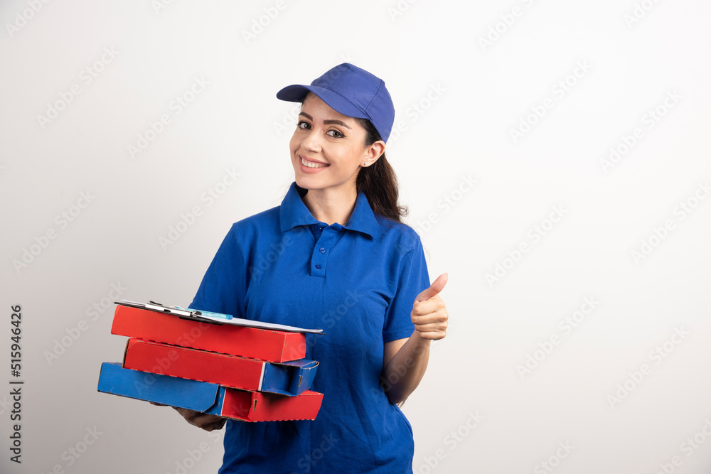 Woman courier with cardboard of pizza and clipboard Woman courier with cardboard of pizza and clipboard