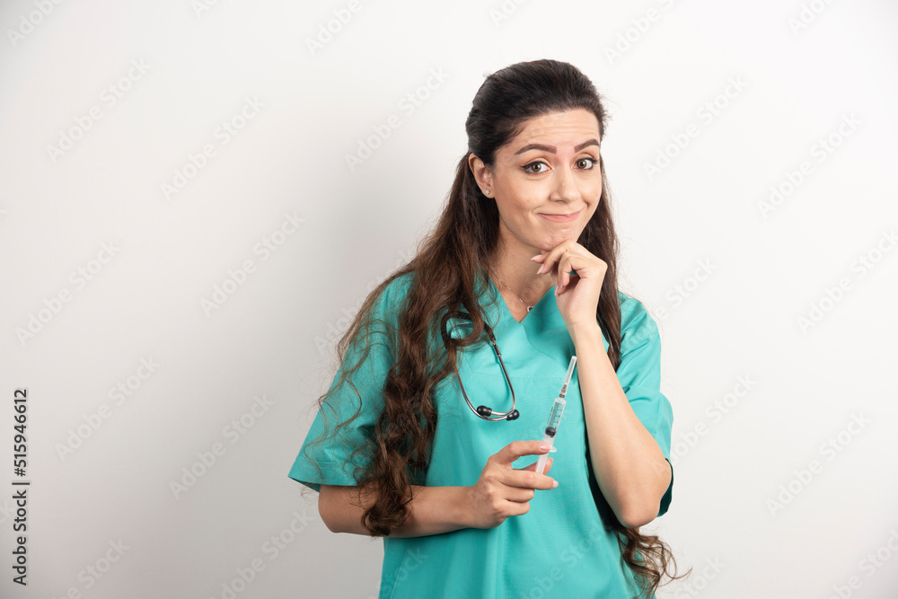 Female nurse with stethoscope holding injection Female nurse with stethoscope holding injection