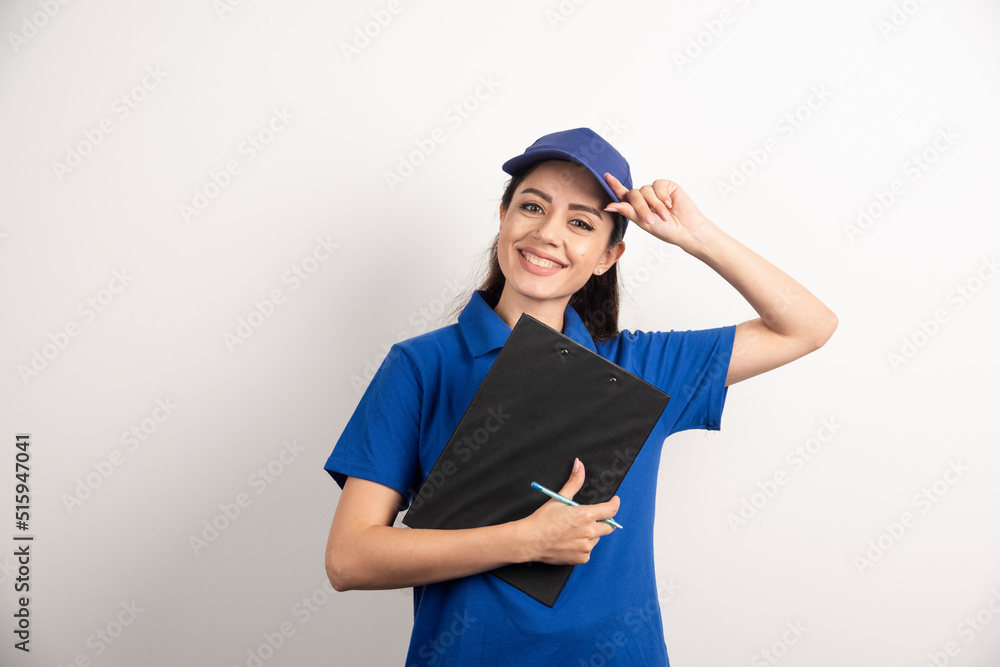 Young female courier in blue scrubs holding a clipboard Young female courier in blue scrubs holding a clipboard