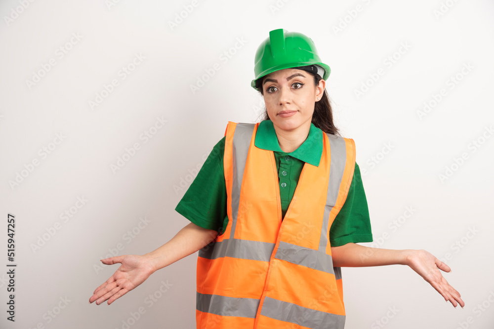 Young woman architect in uniform and helmet