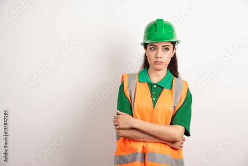 Young woman architect in uniform and helmet
