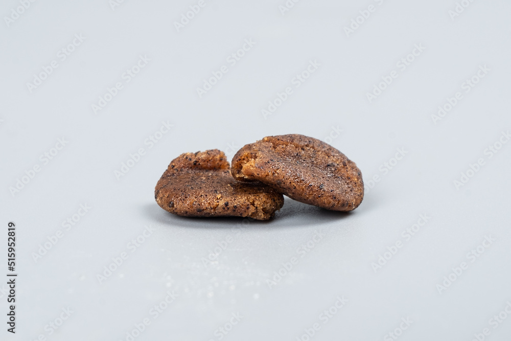 a piece of hashish on a gray background , crumple marijuana trichomes with a high content of thc. a piece of hashish on a gray background , crumple marijuana trichomes with a high content of thc.