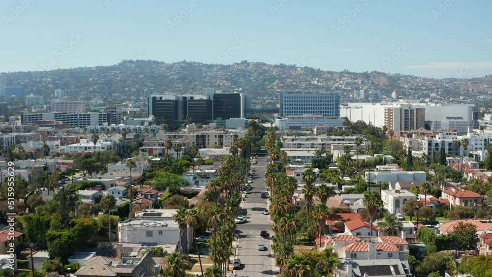 Aerial view of Beverly Hills, tall palm trees, and commercial buildings of LA Aerial view of Beverly Hills, tall palm trees, and commercial buildings of LA