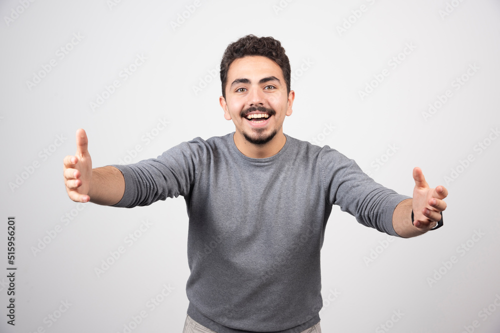 A young man pulling hands towards camera A young man pulling hands towards camera