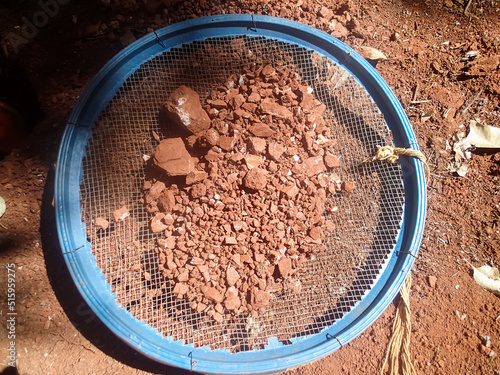 Archaeological excavation: sieve with dirt. Looking for artifacts. photo