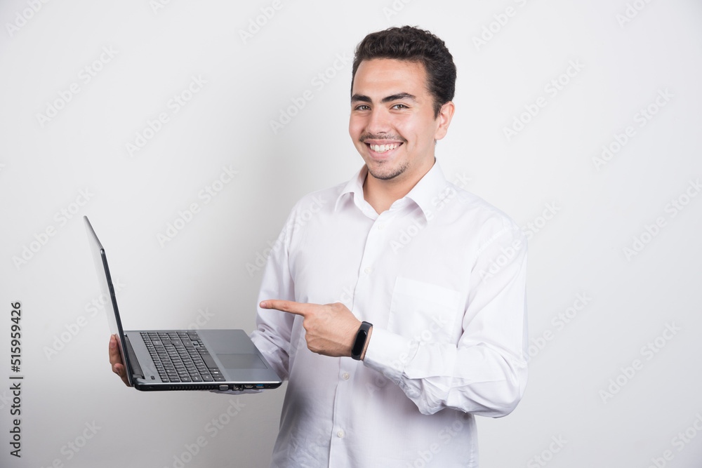 Smiling businessman with laptop posing on white background Smiling businessman with laptop posing on white background