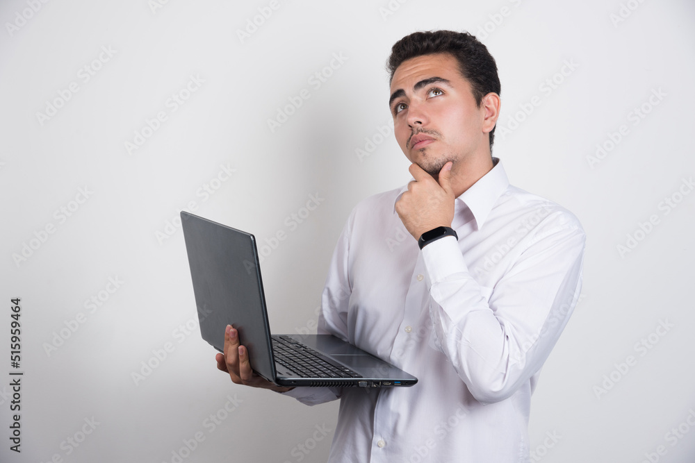 Businessman with laptop thinking on white background Businessman with laptop thinking on white background