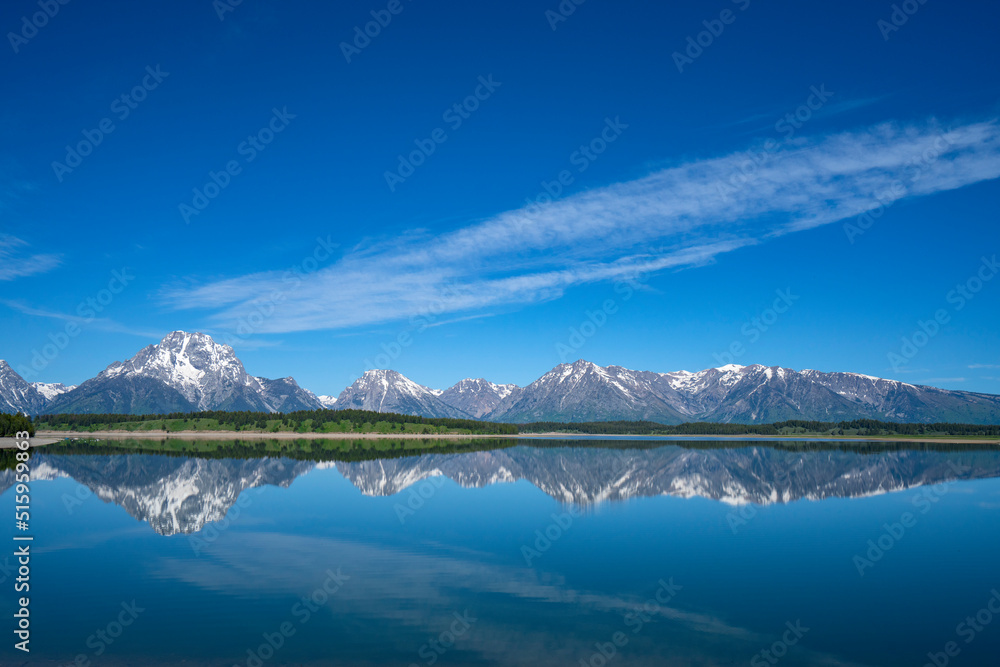 landscape of snow mountain in grand teton reflecting in the lake