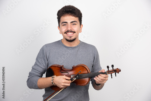 Musician plays violin and looks inspired and positive