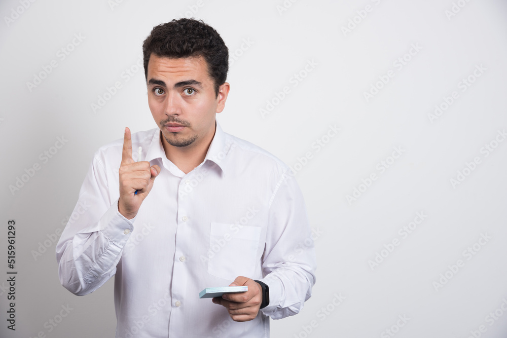 Businessman with memo pads wants a minute on white background Businessman with memo pads wants a minute on white background