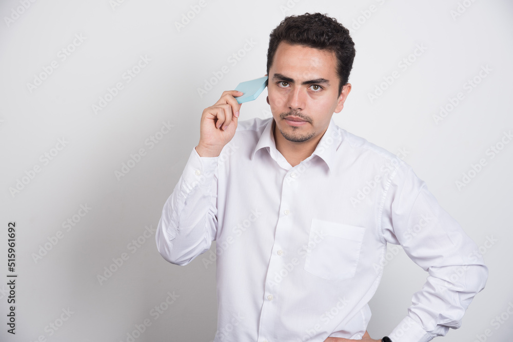 Serious businessman holding memo pads on white background Serious businessman holding memo pads on white background