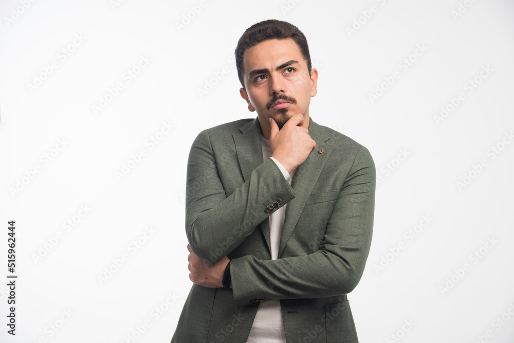 A businessman in dress code looks thoughtful A businessman in dress code looks thoughtful