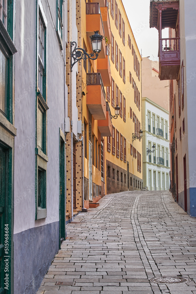 Scenic street view of old vibrant historic houses, residential buildings and traditional infrastructure in alleyway road. Tourism abroad, overseas travel destination in Santa Cruz de La Palma, Spain