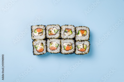 Philadelphia roll with eel and salmon with black masaco on blue background