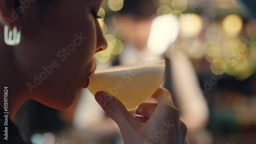 Close up of Attractive Caucasian woman relax and enjoy hangout nightlife and drinking fancy cocktail at luxury restaurant bar. Beautiful female celebrating holiday event party at nightclub in the city