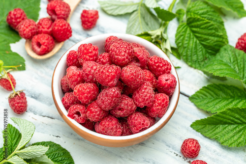 Raspberry in bowl on light background. Organic Raspberry. Red berry. top view with copy space