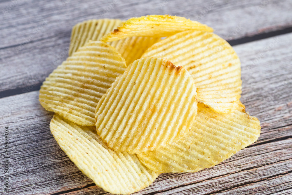 Crispy potato chips on the wood table background. Home made potato chips served with mustard, rosemary, fleur de sel salt on wood background. Copy space. Crispy potato chips on the wood table background. Home made potato chips served with mustard, rosemary, fleur de sel salt on wood background. Copy space.