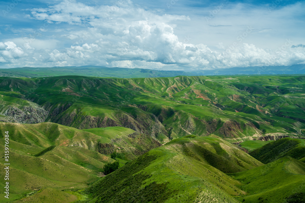 Fototapeta premium The Kalajun grassland in Xinjiang, China. Landscape with hills and clouds.