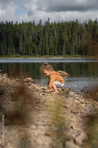 Toddler child girl on lakeshore 
