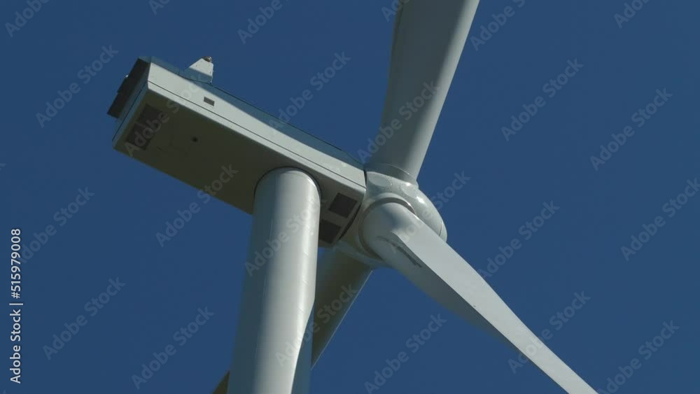 wind turbine close up shadow blade slow rotate blue sky backdrop wind turbine close up shadow blade slow rotate blue sky backdrop
