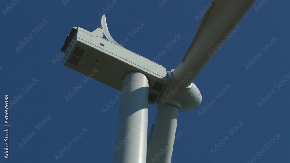 wind turbine close up bending blade slow rotate blue sky backdrop wind turbine close up bending blade slow rotate blue sky backdrop