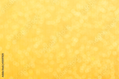 Gold light shiny bokeh abstract blur background with bright round defocus golden pattern.