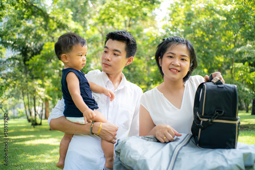 Family with son enjoying relax picnic in green nature park