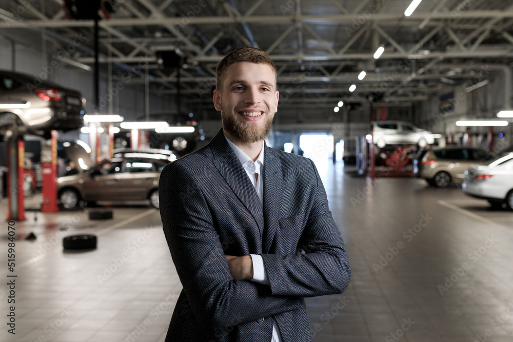 Manager for the acceptance of cars for repair. A man stands against the background of a service station Manager for the acceptance of cars for repair. A man stands against the background of a service station
