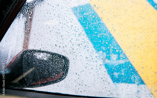 Raindrops on the side window of a car, Close up of raindrops on the window of a car, Macro of drops of water on the windows of a car.