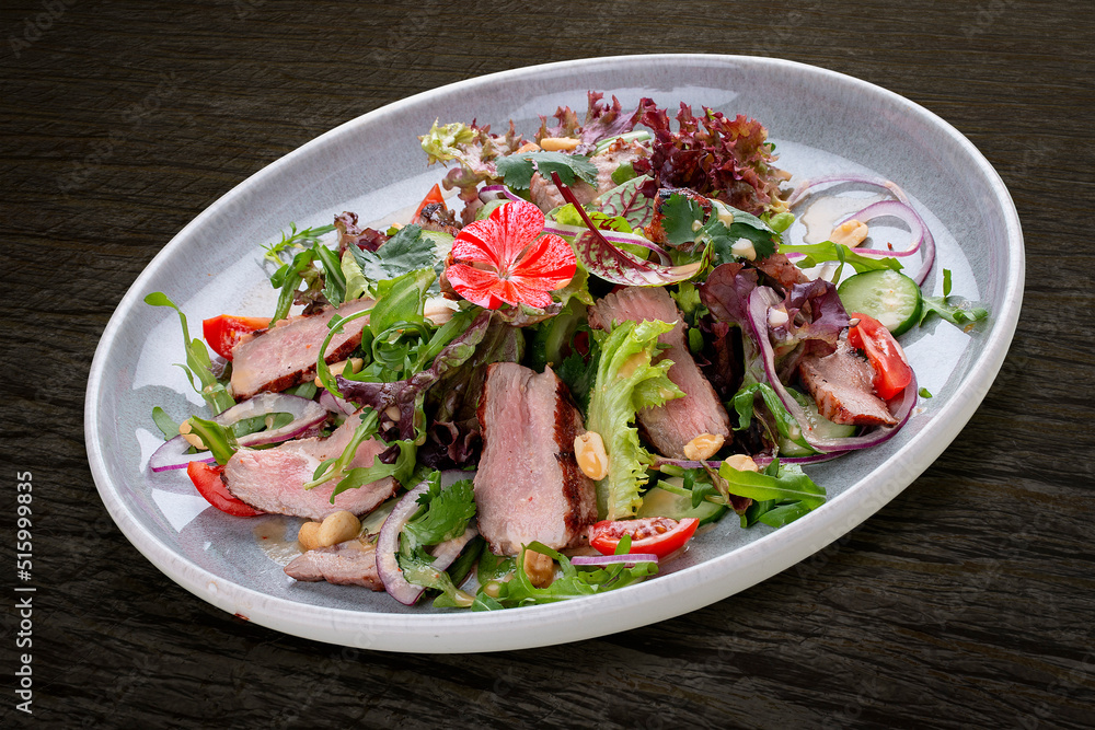 Josper-oven veal salad with sauce. On a dark background, isolated. Josper-oven veal salad with sauce. On a dark background, isolated.