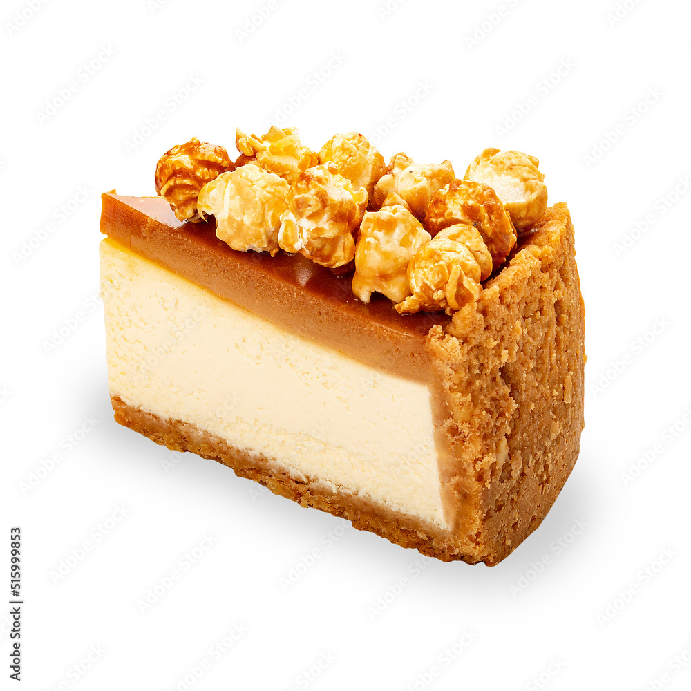 Cheesecake with popcorn and salted caramel. A cut off piece. On a white background, isolated. Cheesecake with popcorn and salted caramel. A cut off piece. On a white background, isolated.