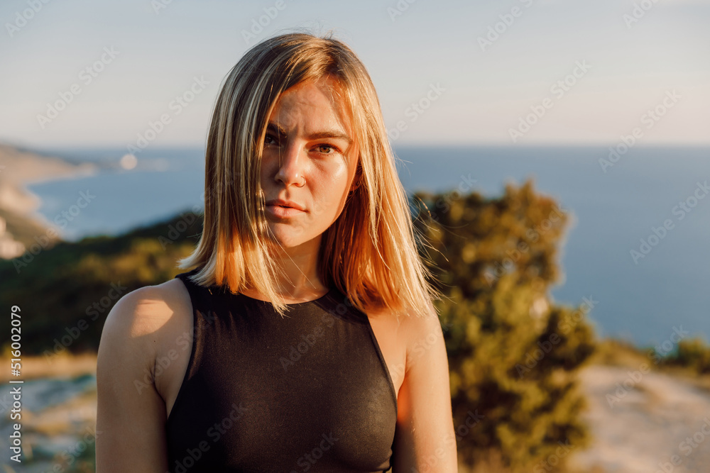 Close up portrait of attractive blonde woman on outdoor with warm tones.