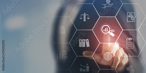 Audit business concept. Examination and evaluation of the financial statement of an organization; income statement, balance sheet, cash flow statement. Businessman touching on audit, smart background.
