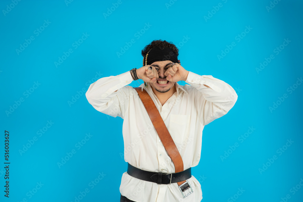 Young pirate feeling angry and put fists to his eyes Young pirate feeling angry and put fists to his eyes